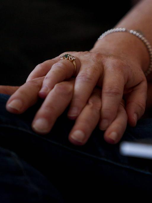 Die Hand einer Frau liegt auf der Hand eines Mannes