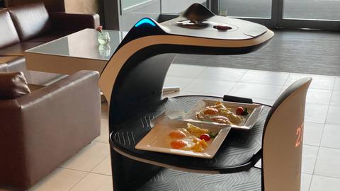 Servierrotober bringt zwei gefüllte Teller in einem Restaurant