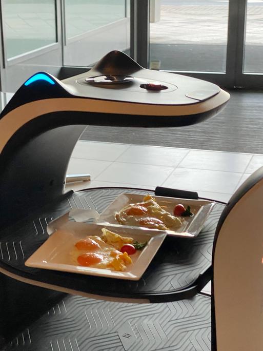 Servierrotober bringt zwei gefüllte Teller in einem Restaurant