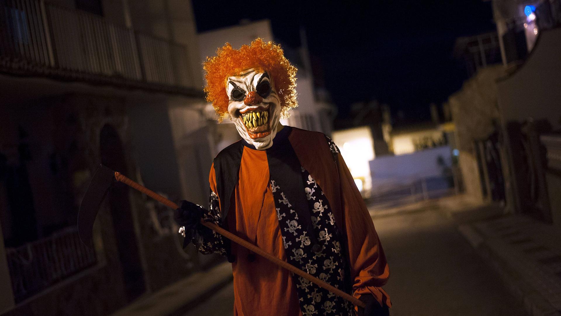 Ein als teuflischer Clown verkleideter Mann. Ein als teuflischer Clown verkleideter Mann.