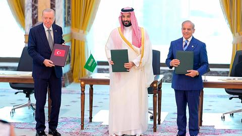 Mohammed bin Salman, Recep Tayyip Erdoğan und Shehbaz Sharif stehen nebeneinander und präsentieren das schlossen den sogenannten "Mekka-Verteidigungspakt" (Photo by Handout / Pakistan Prime Minister's Office / AFP) / RESTRICTED TO EDITORIAL USE - MANDATORY CREDIT "AFP PHOTO /Pakistan Prime Minister's Office/ HANDOUT / " - NO MARKETING NO ADVERTISING CAMPAIGNS - DISTRIBUTED AS A SERVICE TO CLIENTS