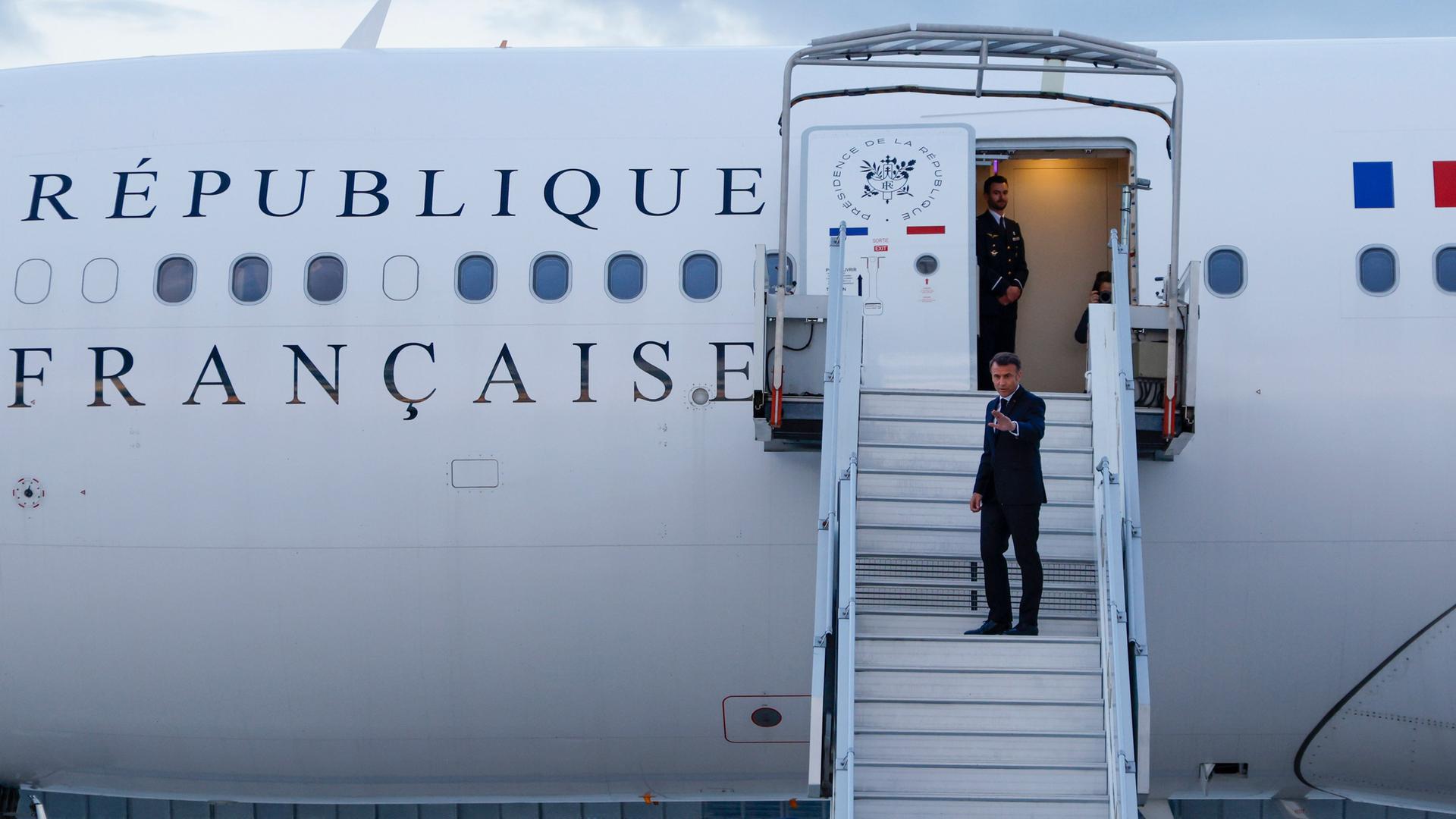 Paris: Frankreichs Präsident Emmanuel Macron winkt, als er auf dem Pariser Flughafen Orly in sein Präsidentenflugzeug steigt, um zur pazifischen Inselgruppe Neukaledonien zu reisen. 