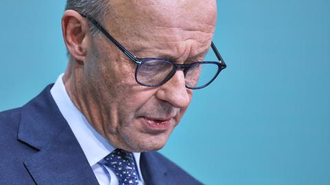 Friedrich Merz blickt bei einer Pressekonferenz nach unten.