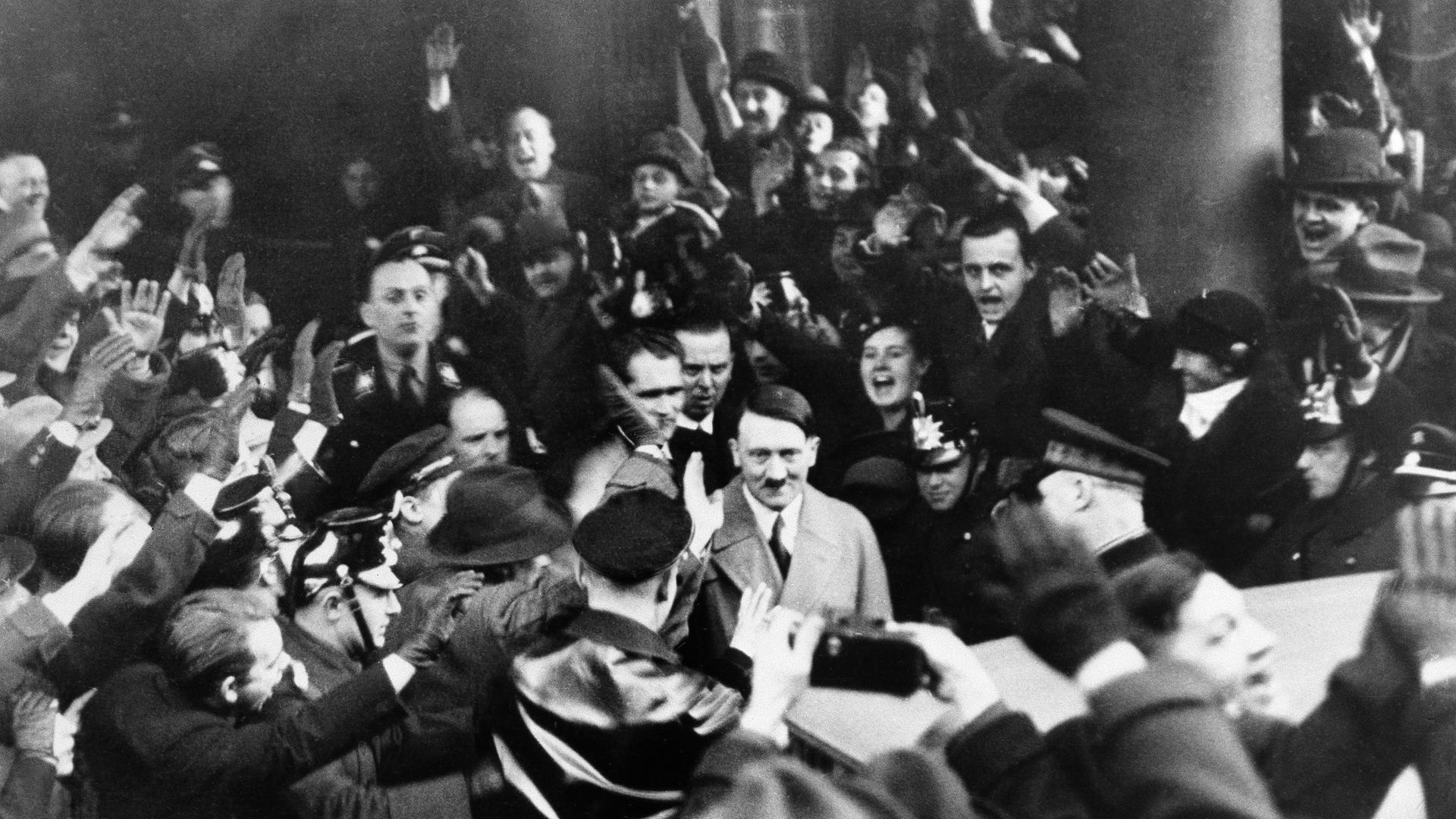 Followers of the Nationalist Socialist Party cheer their leader Adolf Hitler, as he left the Hotel Kaiserhof in Berlin, Jan. 30, 1933 following his appointment by President Von Hindenburg as Chancellor of Germany. The Nazi chieftain returns their Fascist salute. (AP Photo) Followers of the Nationalist Socialist Party cheer their leader Adolf Hitler, as he left the Hotel Kaiserhof in Berlin, Jan. 30, 1933 following his appointment by President Von Hindenburg as Chancellor of Germany. The Nazi chieftain returns their Fascist salute. (AP Photo)