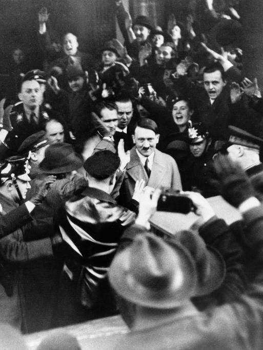 Followers of the Nationalist Socialist Party cheer their leader Adolf Hitler, as he left the Hotel Kaiserhof in Berlin, Jan. 30, 1933 following his appointment by President Von Hindenburg as Chancellor of Germany. The Nazi chieftain returns their Fascist salute. (AP Photo)