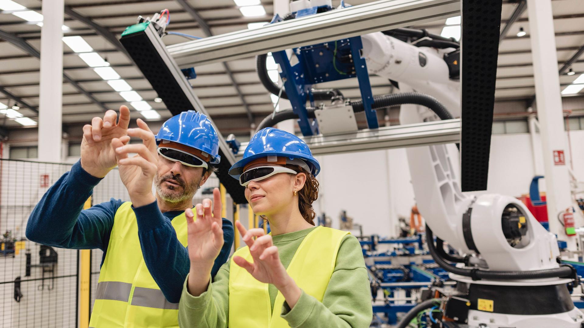 Mature engineers wearing smart glasses in robotics factory model released, Symbolfoto property released, JCCMF09824