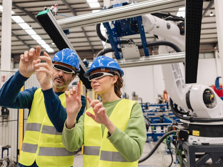 Mature engineers wearing smart glasses in robotics factory model released, Symbolfoto property released, JCCMF09824