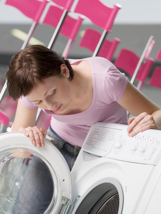 Eine junge Frau sucht eine Waschmaschine aus in der Shopping Mall von Woronesch.