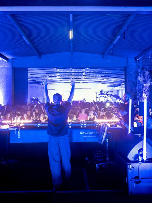 DJ Alle Farben hebt die Hände in die Höhe und heizt dem Publikum ein. Bei einer besonderen Party zum 150-jährigen Jubiläum der Bayreuther Festspiele hat der DJ Motive aus Wagners klassischen Werken in seine elektronischen Live-Sets einfließen lassen.