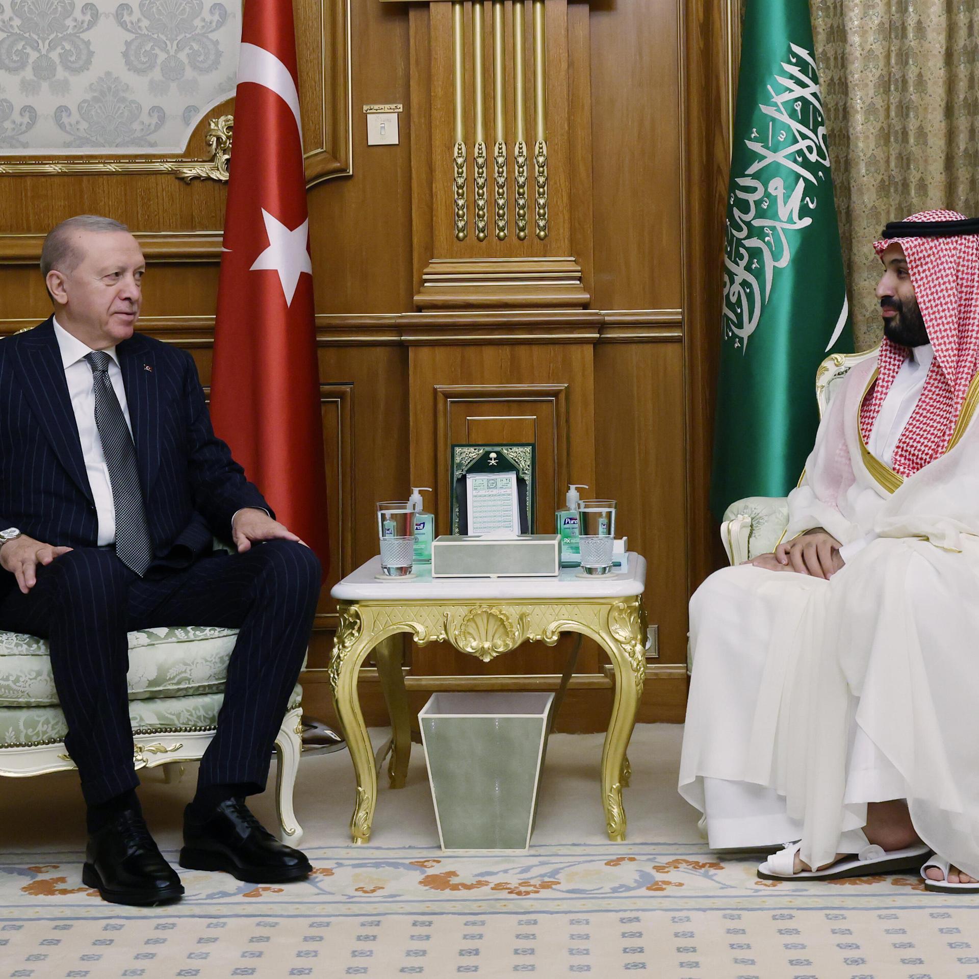 Erdogan und Prinz Mohammad bin Salman sitzen sich in Sesseln gegenüber, hinter ihnen die jeweiligen Landesfahnen.