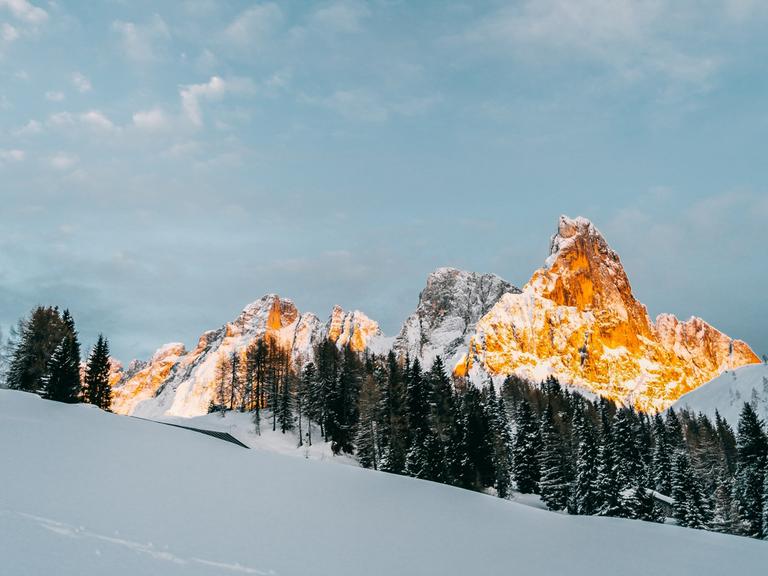 Blick auf Sonnen beschienene Berge im Schnee.