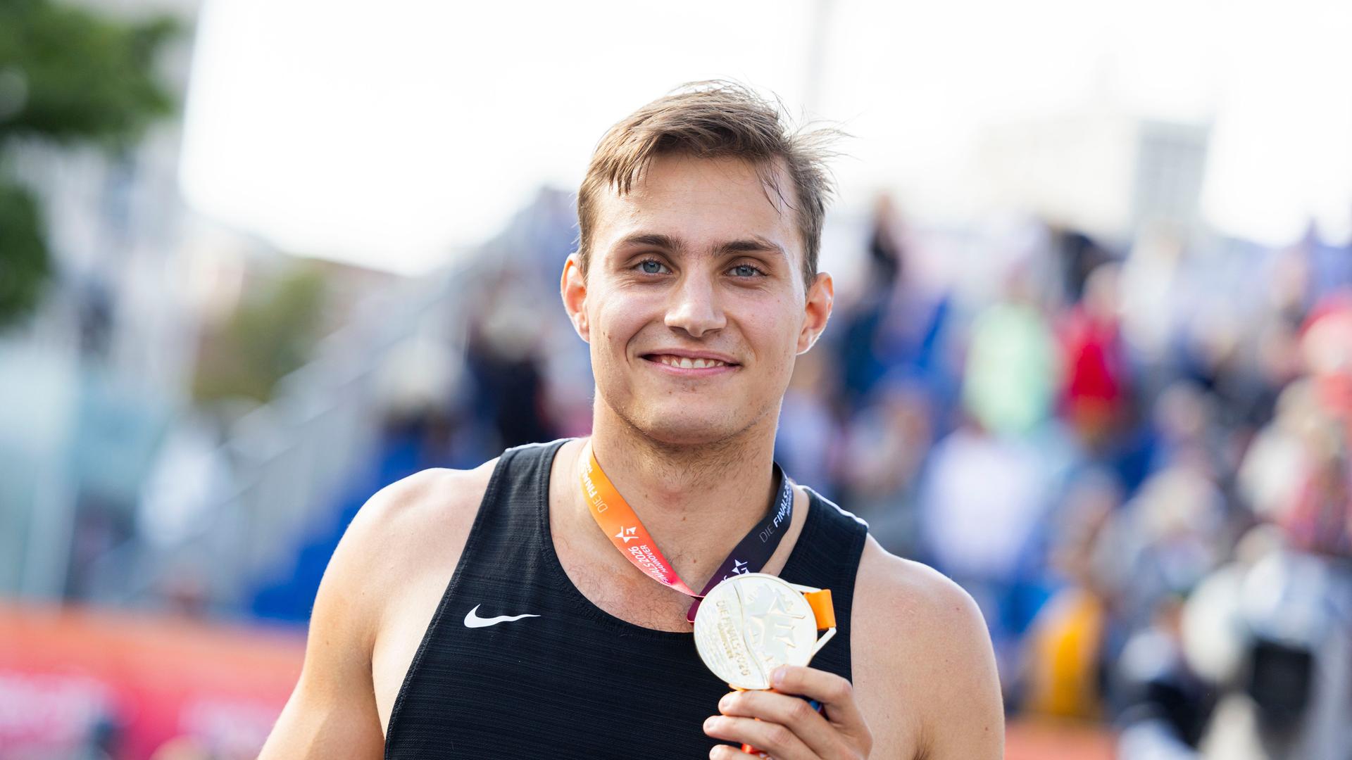 Marec Metzger hält die Goldmedaille zur Deutschen Meisterschaft im Stabhochsprung in seiner Hand. Er strahlt. Marec Metzger hält die Goldmedaille zur Deutschen Meisterschaft im Stabhochsprung in seiner Hand. Er strahlt.