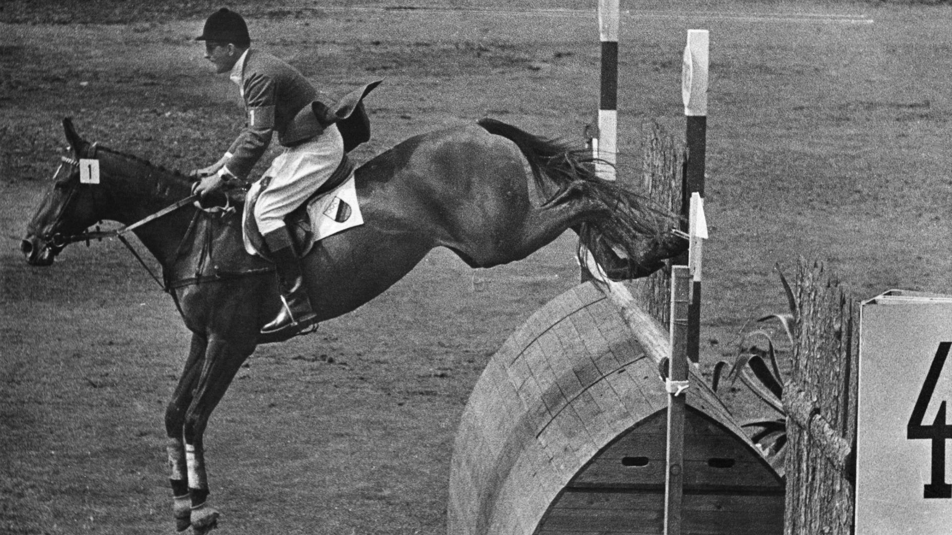 Der deutsche Springreiter Hans Günter Winkler bewältigt auf seiner "Wunderstute" Halla den entscheidenden Ritt beim Jagdspringen während der Olympischen Reiterspiele in Stockholm am 17. Juni 1956 fehlerfrei und sichert sich damit den Olympiasieg
