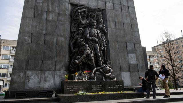 Menschen stehen vor dem Denkmal der Helden des Ghettos in Warschau, das zum Gedenken des Aufstands im Warschauer Ghetto 1943 errichtet wurde.