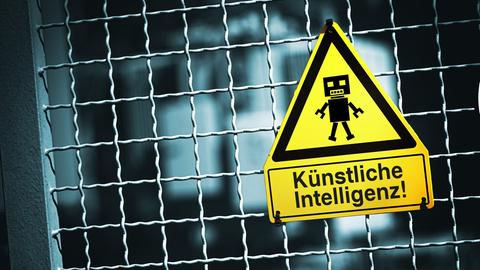 An einem Tor hängt ein Warnschild mit einer Roboterfigur, darunter steht "Künstliche Intelligenz" An einem Tor hängt ein Warnschild mit einer Roboterfigur, darunter steht "Künstliche Intelligenz"
