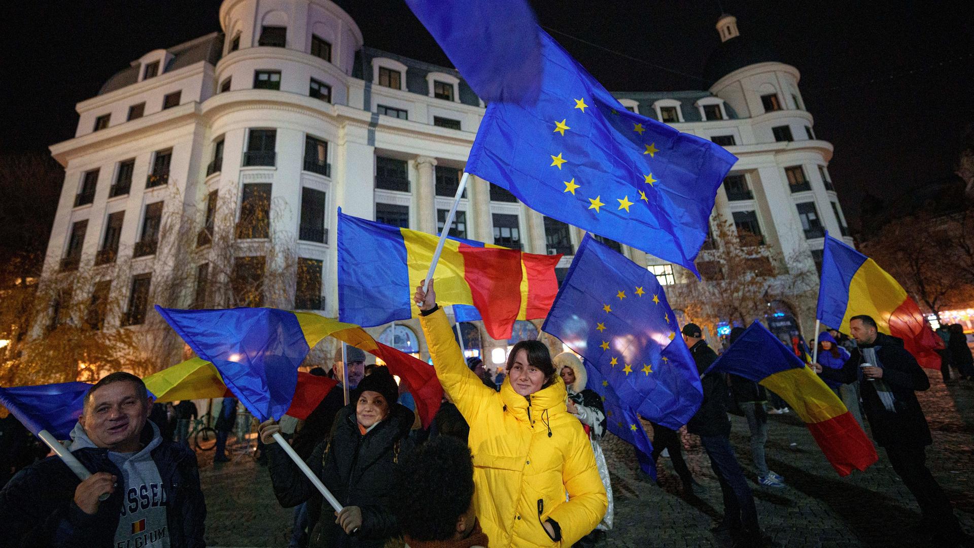 Menschen schwenken rumänische und EU-Flaggen während einer pro-europäischen Kundgebung in Bukarest. 