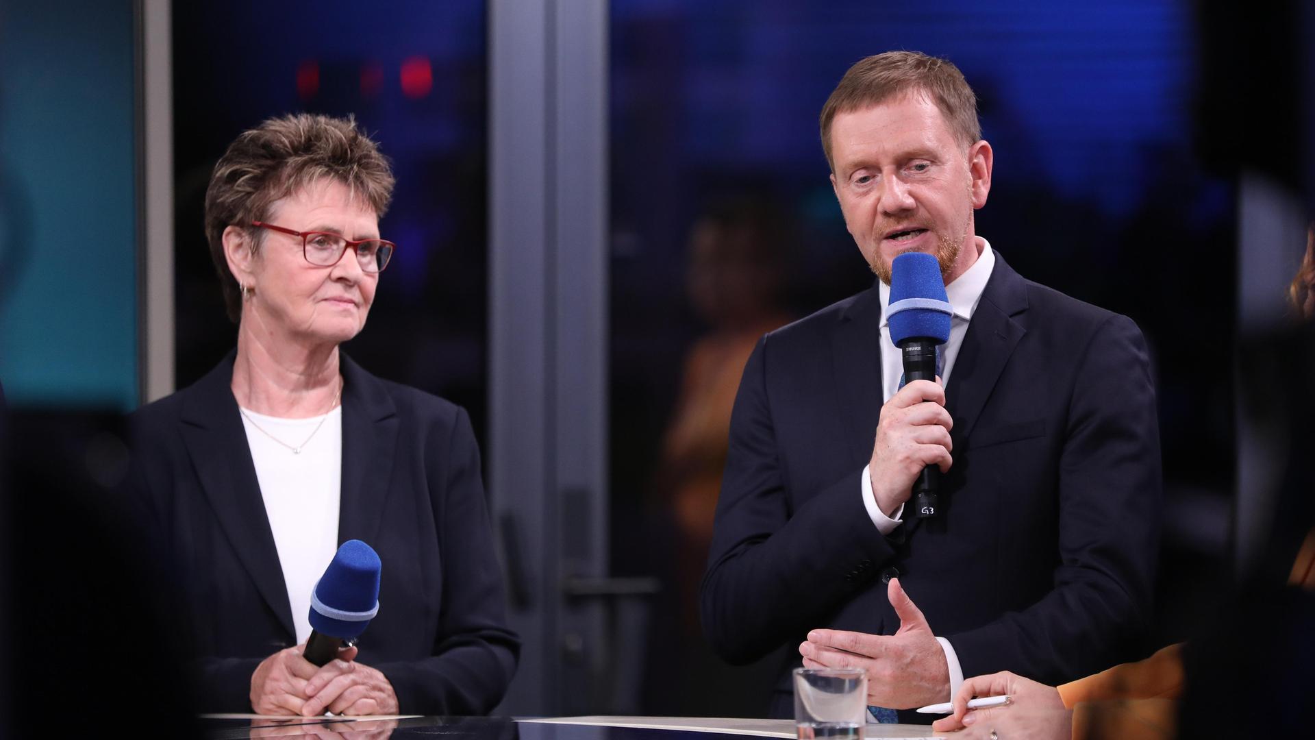 BSW-Spitzenkandidatin Sabine Zimmermann und Sachsens Ministerpräsident Michael Kretschmer, CDU, begegnen sich bei einem TV-Interview