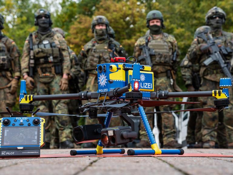 Gemeinsame Einsatzübung der Bayerischen Polizei und der Deutschen Bundeswehr RoadTEX 2025 (Übung Anschlag im Verkehrsraum). Eine Polizeidrohne steht einsatzbereit vor einer Formation von Bundeswehrsoldaten Gemeinsame Einsatzübung der Bayerischen Polizei und der Deutschen Bundeswehr RoadTEX 2025 (Übung Anschlag im Verkehrsraum). Eine Polizeidrohne steht einsatzbereit vor einer Formation von Bundeswehrsoldaten