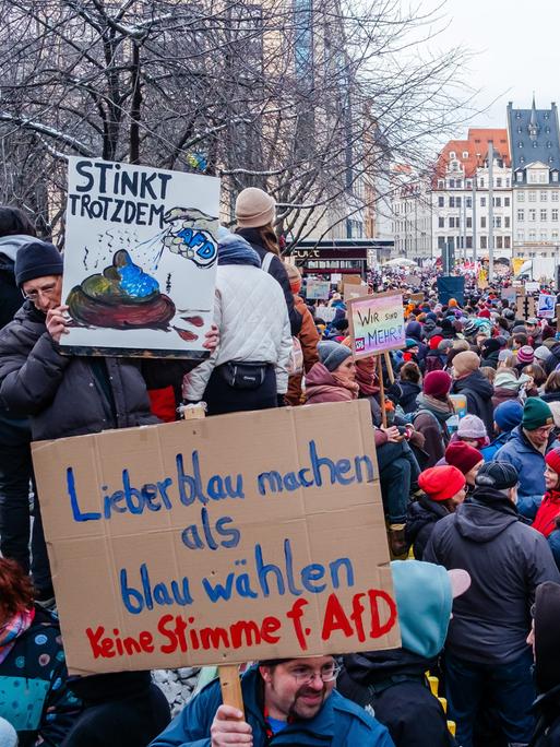 Demonstranten mit Plakaten haben sich in der Petersstrasse und rund um den Marktplatz von Leipzig versammelt.