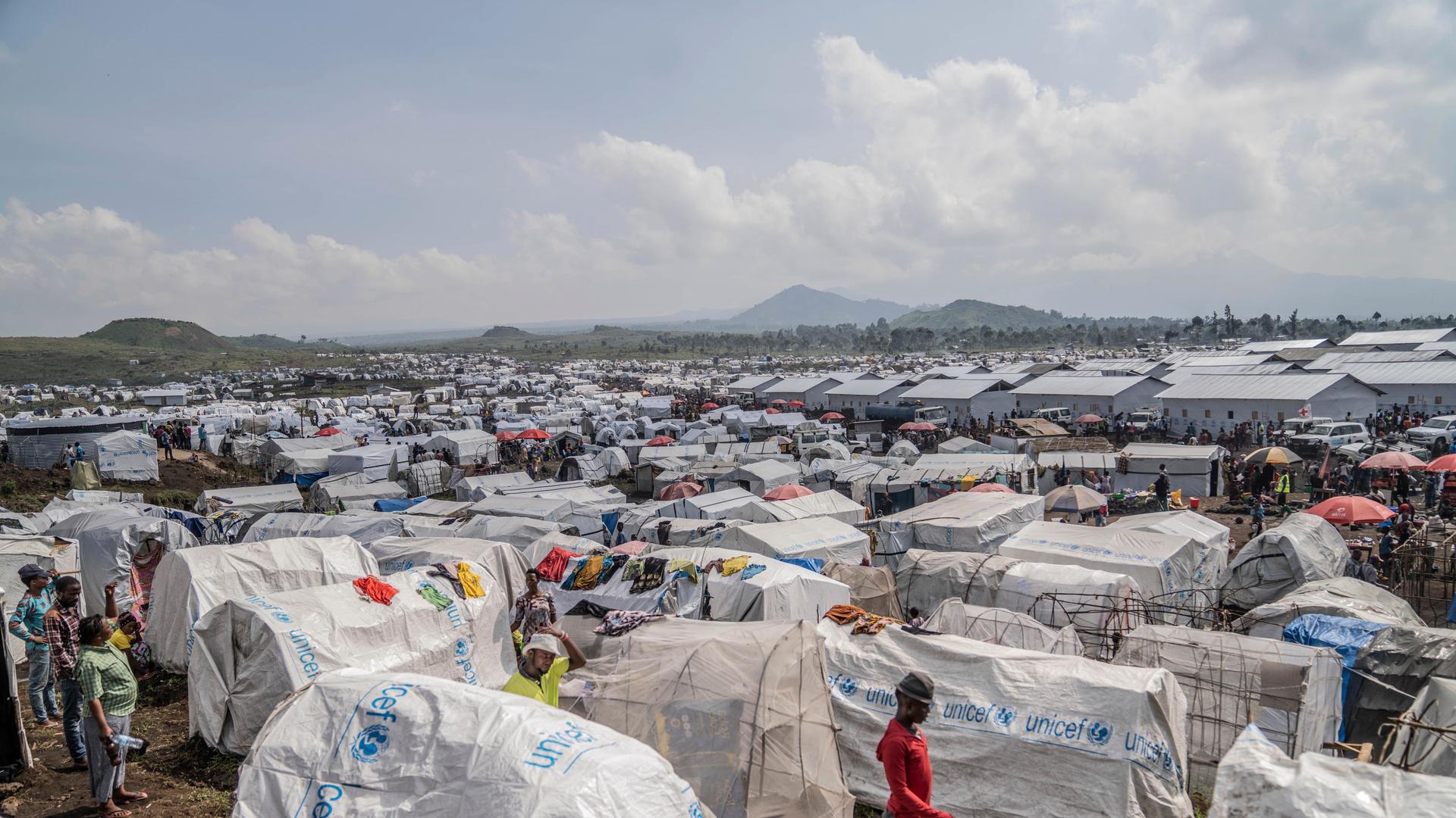 People displaced by the ongoing fighting between Congolese forces and M23 rebels gather in a camp on the outskirts of Goma, Democratic Republic of Congo