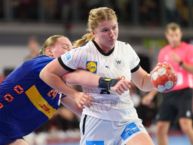 Nina Engel hat den Ball. Eine Gegenspielerin hängt an ihr.