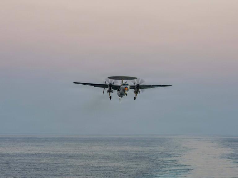 Das Foto zeigt eine E-2D Hawkeye in den USA über dem Meer. Die Waffe wurde beim Angriff auf den Iran eingesetzt.