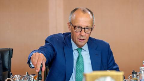 Bundeskanzler Friedrich Merz (CDU) läutet die Glocke zu Beginn der Sitzung des Bundeskabinetts im Kanzleramt. 