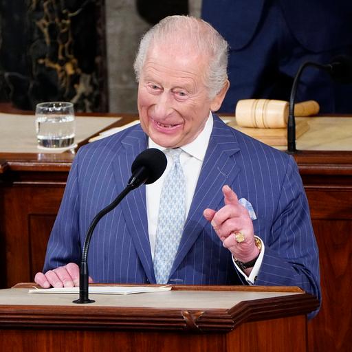 König Charles steht am Redepult im US-Kongress in Washington und spricht in ein Mikrofon. Er schmunzelt dabei.