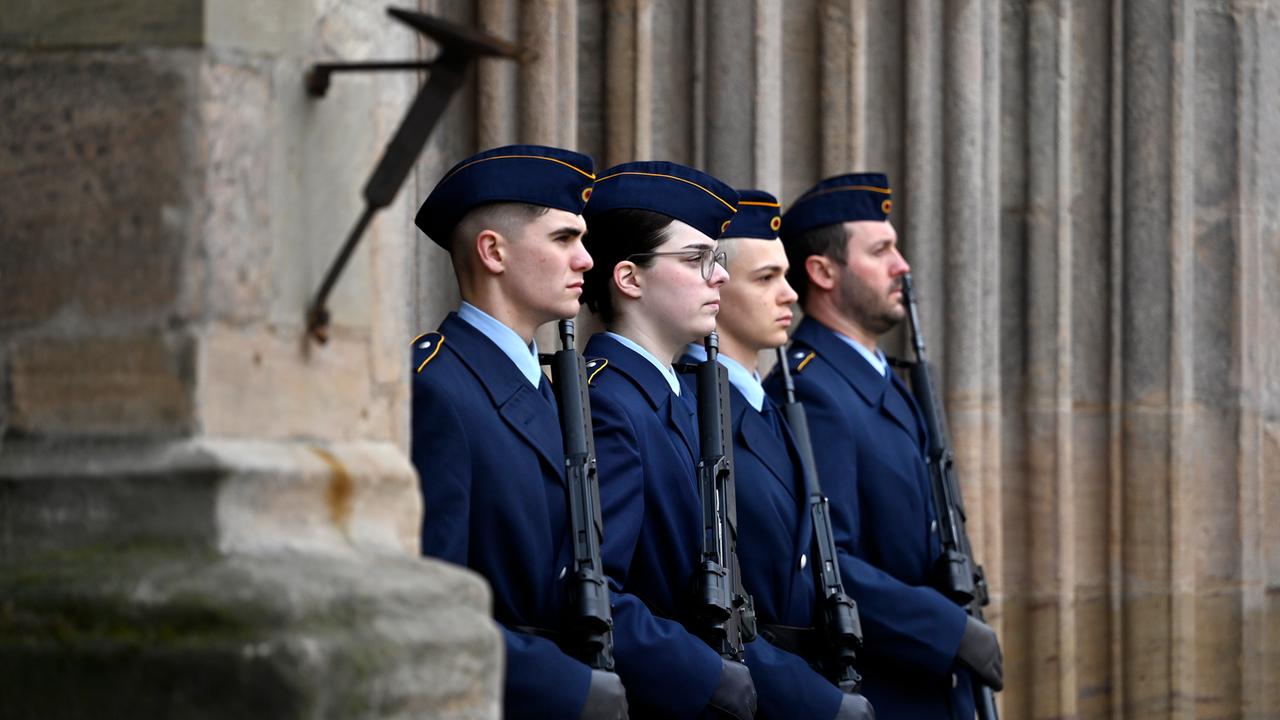 Rekruten und Rekrutinnen der Bundeswehr stehen mit einem Gewehr in der Hand bei einem öffentlichen Gelöbnis der Bundeswehr in Nürnberg stramm.