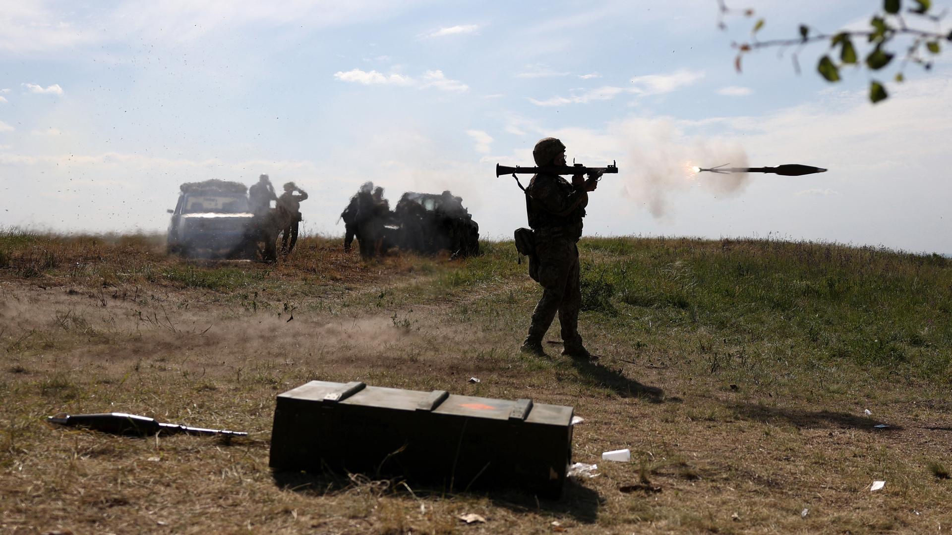Ein ukrainischer Soldat feuert während einer Übung einen Raketenwerfer ab.