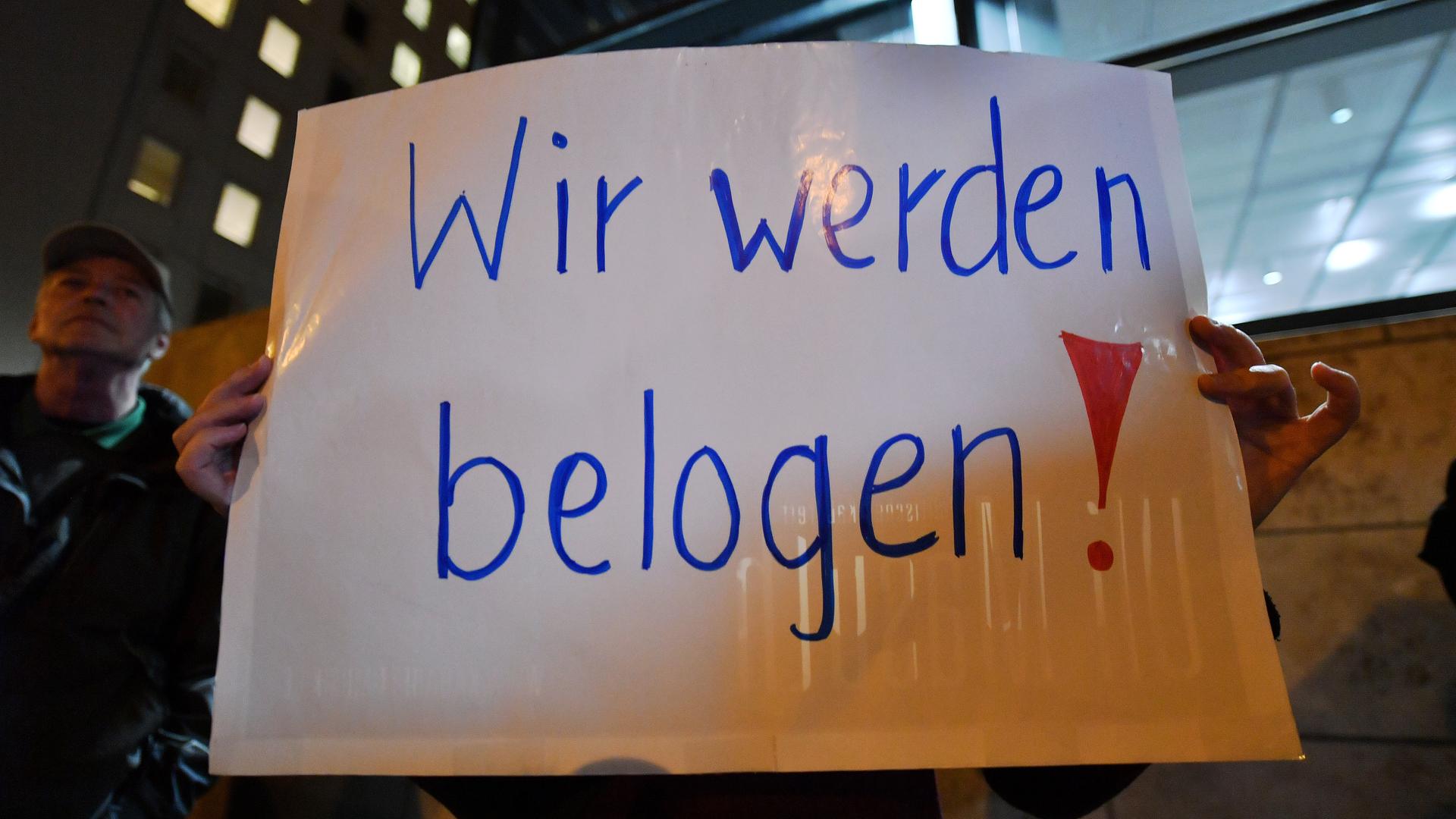 "Wir werden belogen" steht auf dem Plakat, das eine Frau bei einer Demonstration vor dem Thüringer Landtag in den Händen hält.