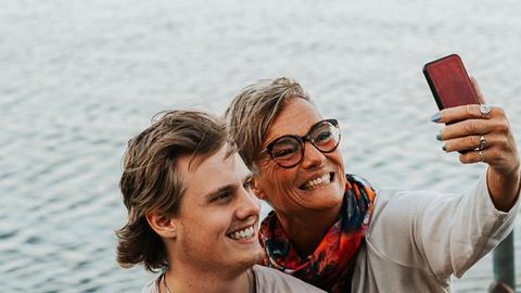 Eine Mutter macht neben ihrem Sohn ein Selfie.