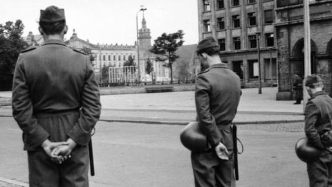 Absperrposten der Deutschen Volkspolizei kurz vor der Sprengung der Paulinerkirche am 30. Mai 1968 in Leipzig. Im Hintergrund der Turm der Nikolaikirche. Neben der Paulinerkirche wurde auch das Augusteum einschließlich Johanneum und Albertinum der Universität Leipzig, von 1953 bis Februar 1991 Karl-Marx-Universität Leipzig, gesprengt. Die Universität Leipzig (Alma mater lipsiensis) feiert 2009 ihr 600-jähriges Bestehen. Foto: Universität Leipzig +++(c) dpa - Report+++ | Verwendung weltweit