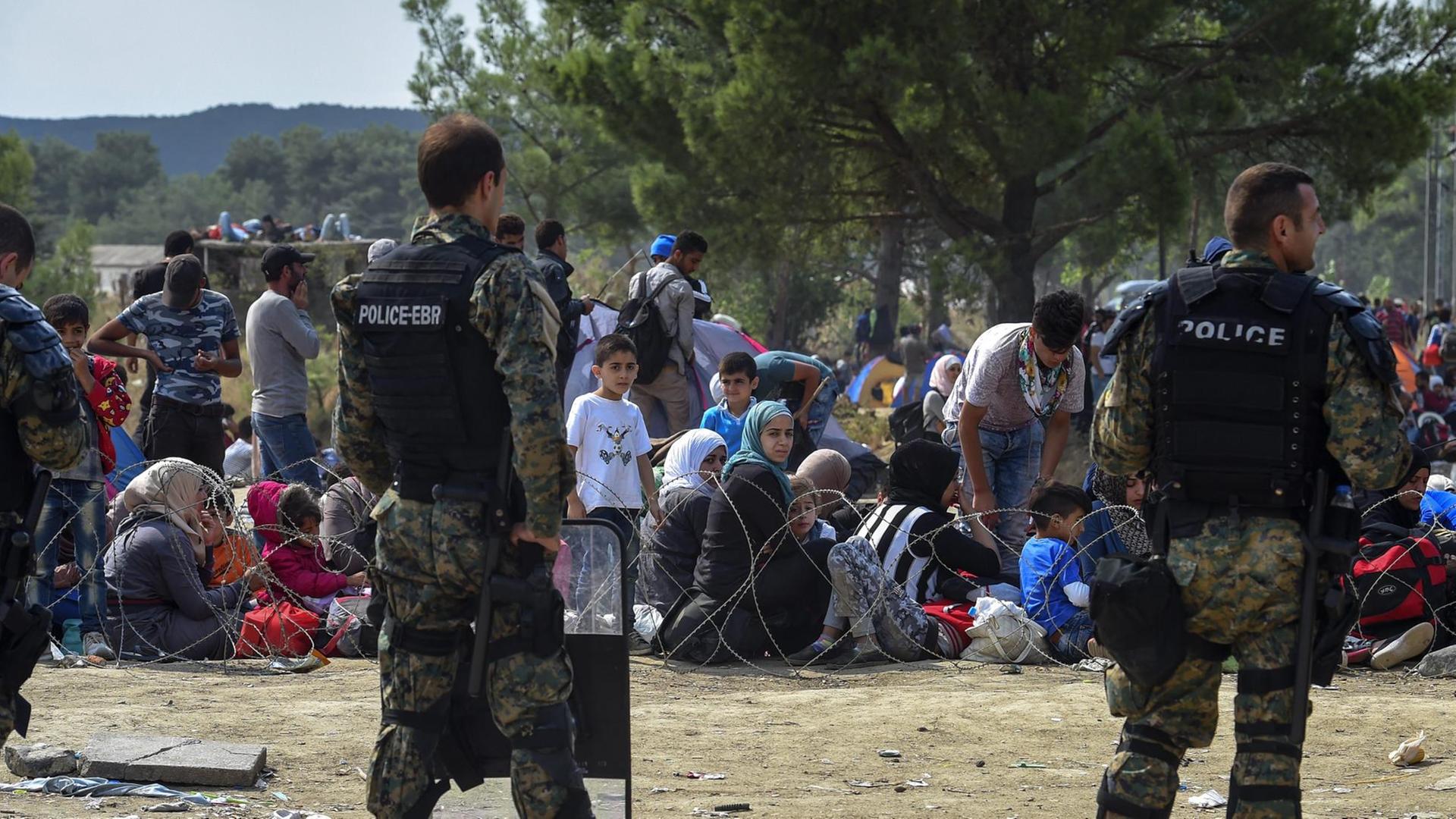 Sicherheitskräfte und Flüchtlinge an der Grenze zwischen Griechenland und Mazedonien