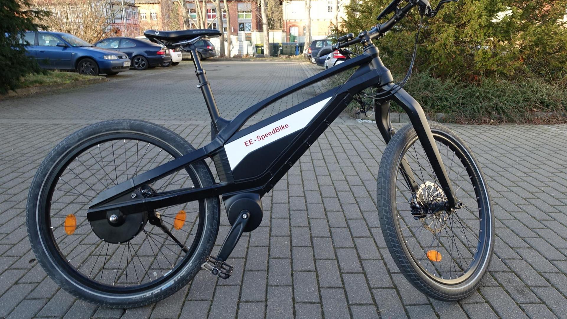 Ein Prototyp eines kettenlosen und elektronisch gesteuerten Fahrrads steht auf einer asphaltierten Fläche