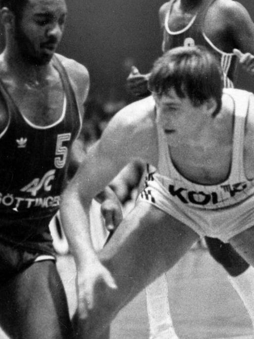 Basketballspieler Wilbert Olinde vom ASC Göttingen spielt am 31.03.1984 in der Verteidigung gegen Stefan Brunnert vom BSC Saturn Köln.
