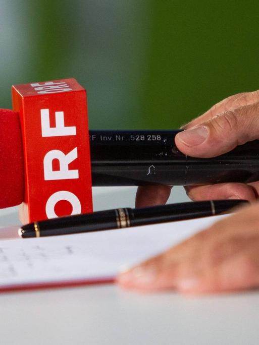 Ein Mikrofon mit der Aufschrift des österreichischen Rundfunks ORF liegt auf einem Tisch.