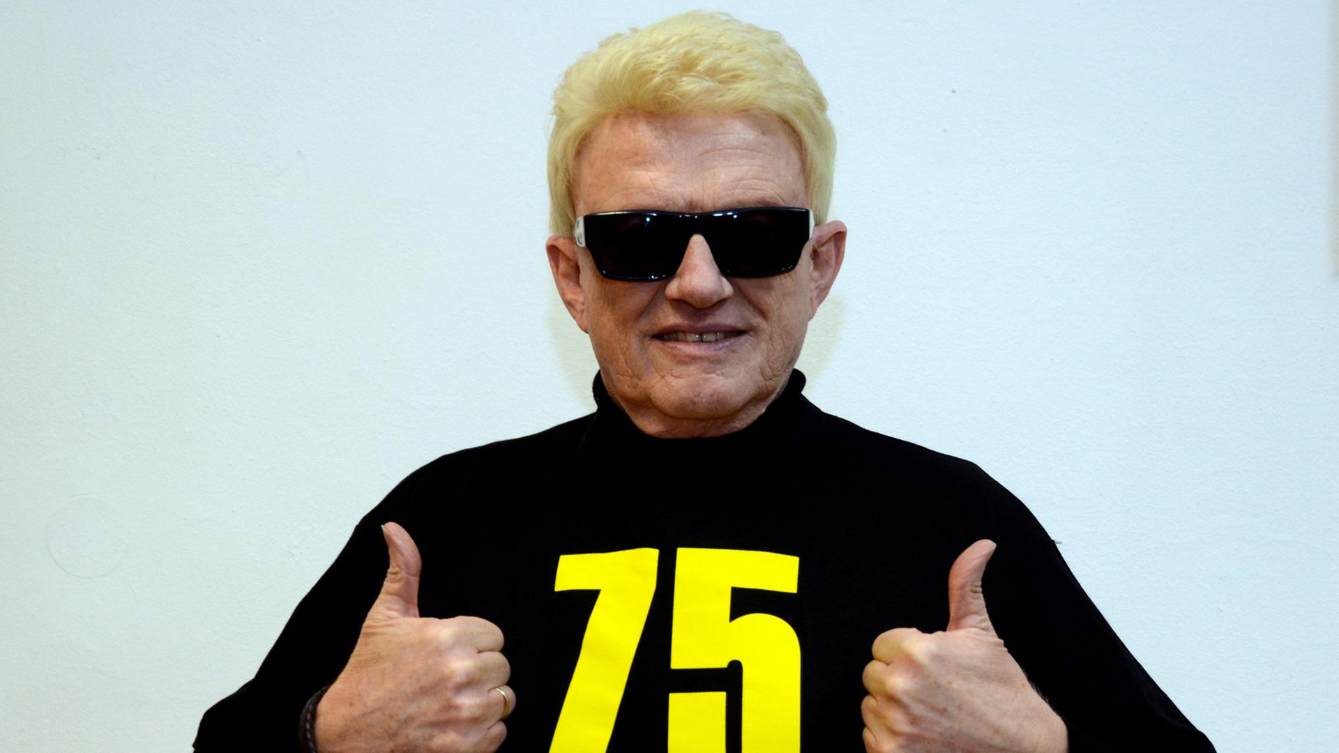 Der deutsche Sänger Heino streckt die Daumen nach oben und posiert in einem T-Shirt mit der Aufschrift "75 Jetzt erst recht".