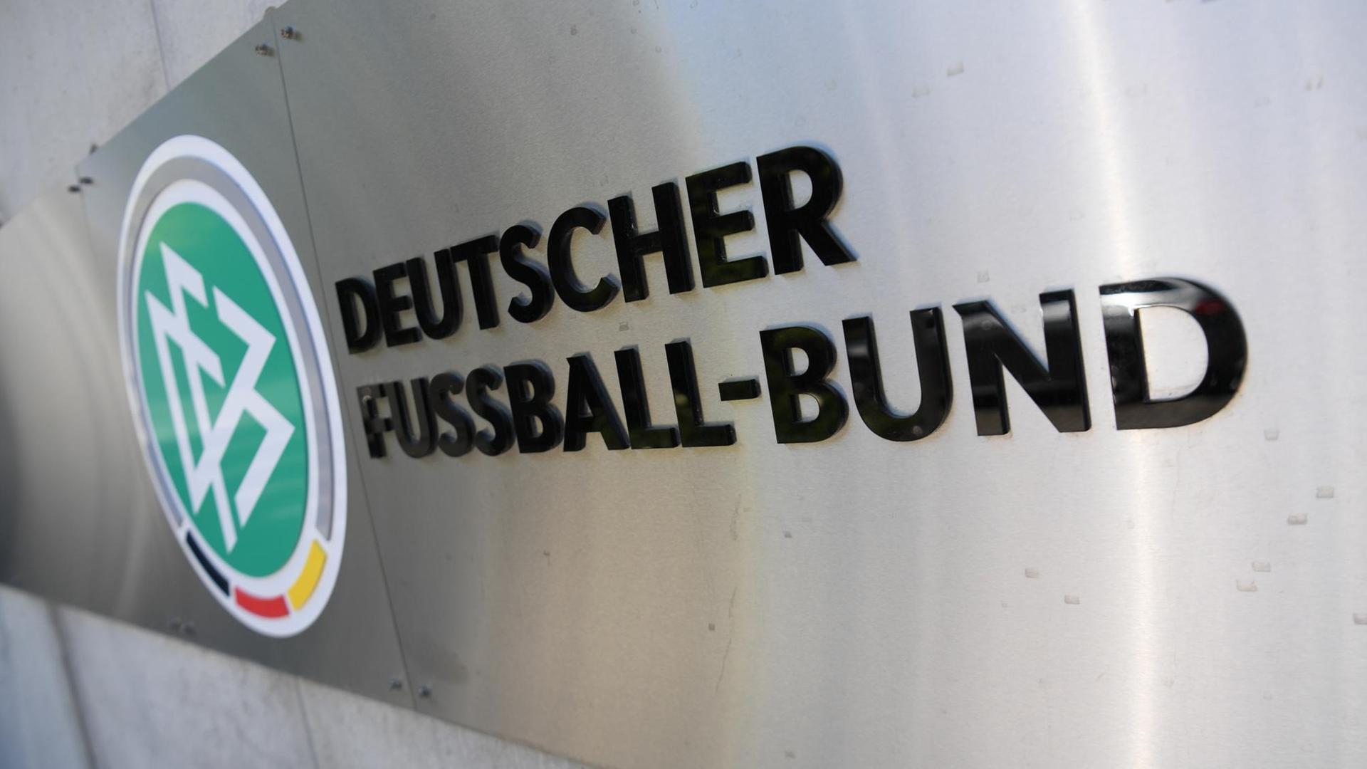 Der schwarze Schriftzug prangt auf einer Metalltafel neben dem grün-weißen DFB-Logo an einer Wand. Der schwarze Schriftzug prangt auf einer Metalltafel neben dem grün-weißen DFB-Logo an einer Wand.