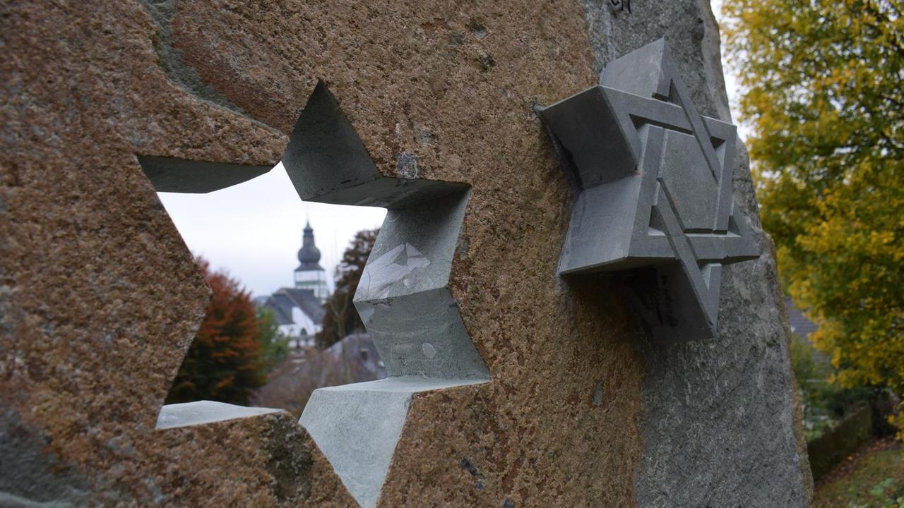 Der Davidstern am jüdischen Friedhof in Attendorn mit dem Sauerländer Dom im Hintergrund