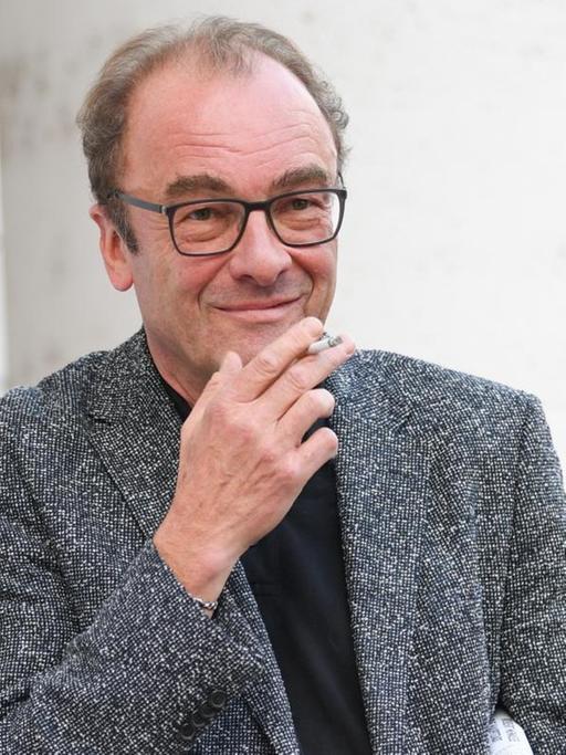 Der österreichische Autor Robert Menasse blickt bei einer Lesung in die Kamera.
