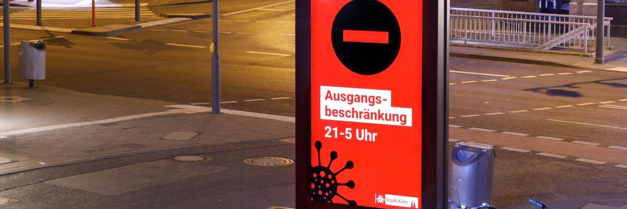 Unter anderem in Köln gelten Ausgangsbeschränkungen, auf die im öffentlichen Raum hingewiesen wird. 