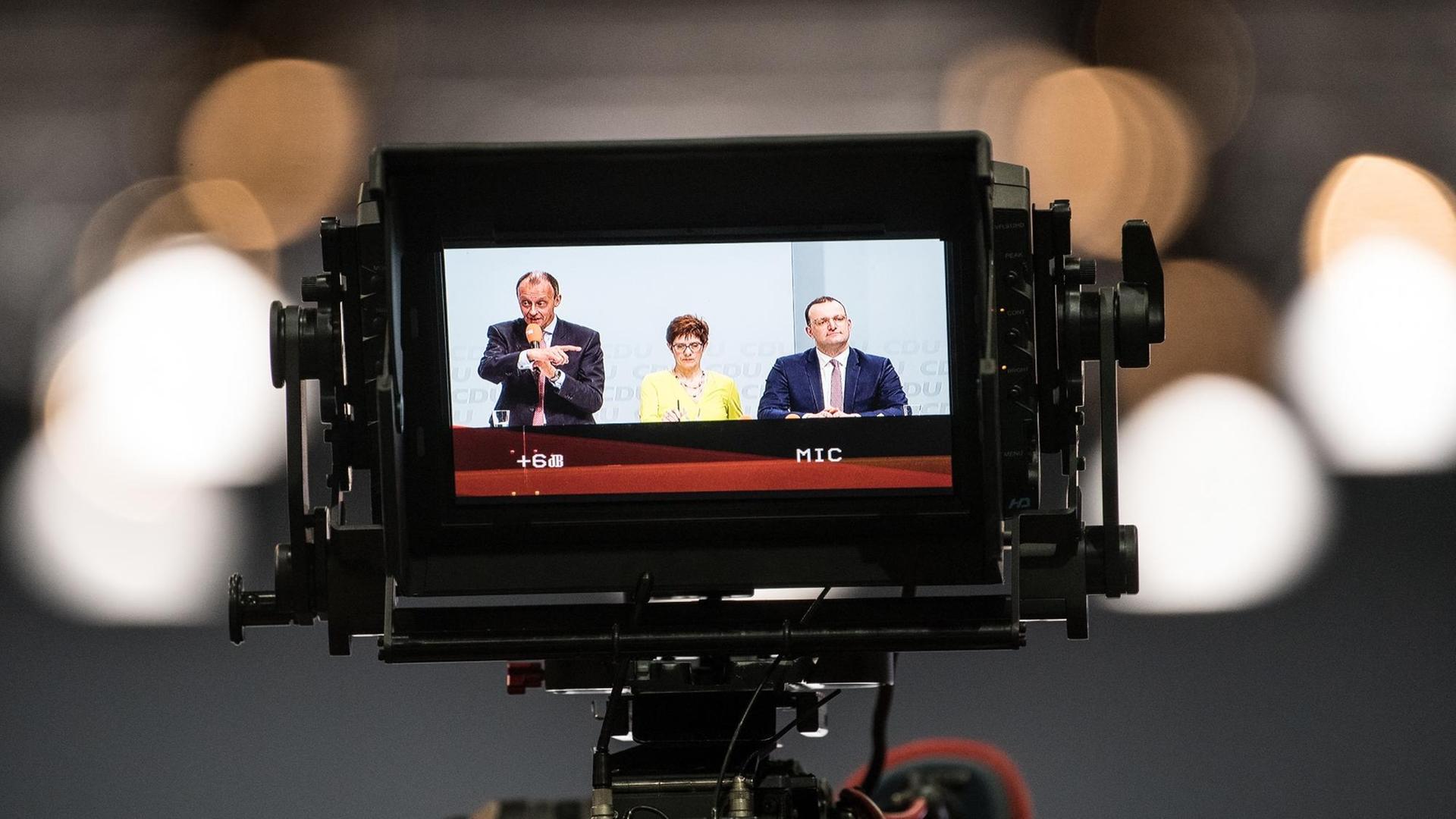 Der ehemalige Unionsfraktionschef Friedrich Merz, Generalsekretärin Annegret Kramp-Karrenbauer und Gesundheitsminister Jens Spahn sind während einer Regionalkonferenz der CDU auf einem Monitor einer Fernsehkamera zu sehen.