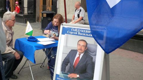 Auf einer Straße in Weißrussland sammeln Kandidaten Unterschriften. Auf einem Wahlplakat ist der Kandidat Sergej Wassilewitsch Gajdukewitsch abgebildet, er ist einer der Bewerber um das Präsidentenamt und Vorsitzender der Liberaldemokratischen Partei.