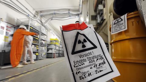 Ein Schild warnt in der ehemaligen Gleisdurchfahrt des Kernkraftwerks Würgassen (Landkreis Höxter) vor erhöhter radioaktiver Strahlung, die von den gelben Fässern (rechts) ausgeht.