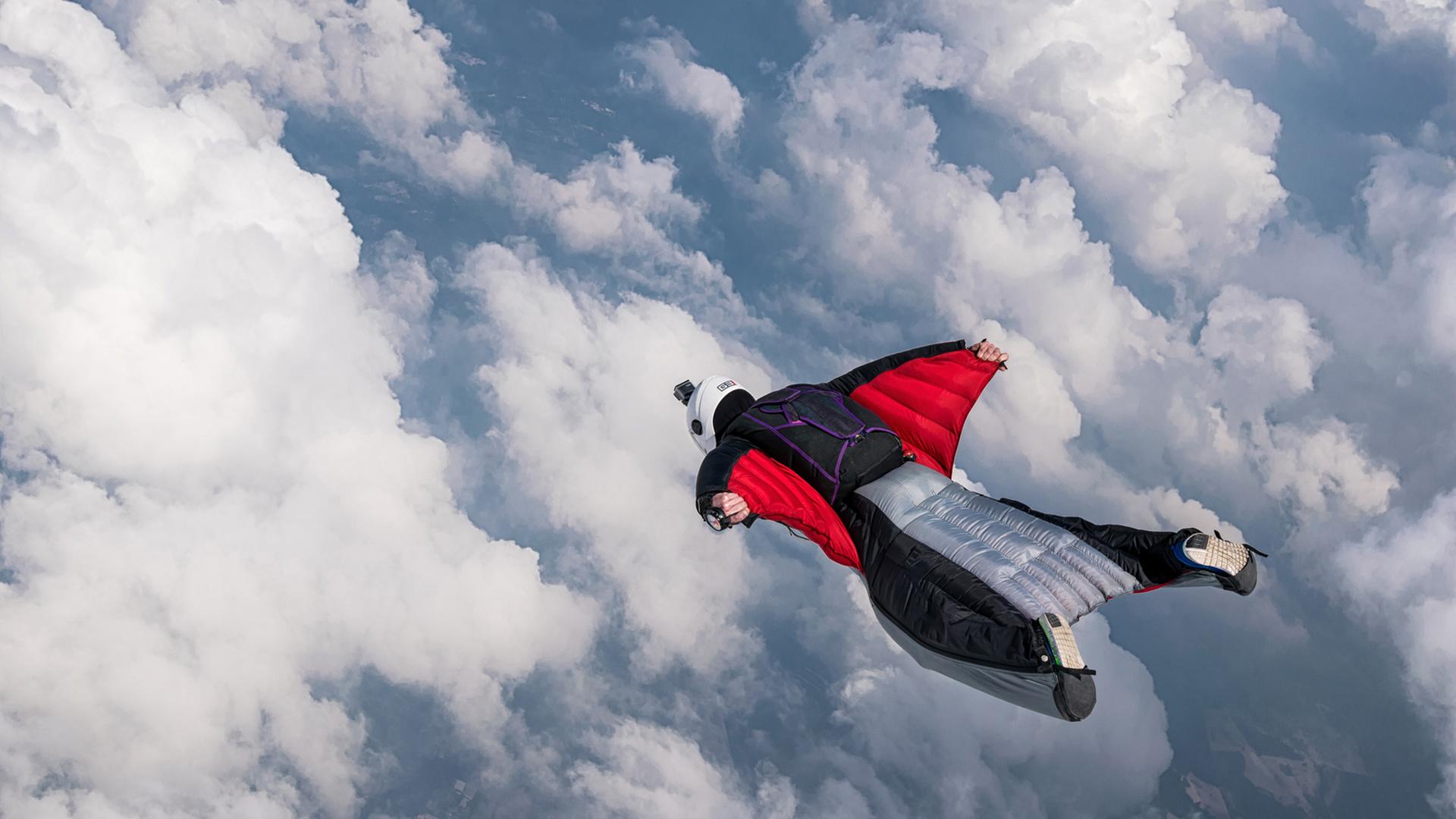 Ein Fallschirmspringer in freiem Fall. wing.suit - Dramatische Dreiecksgeschichte