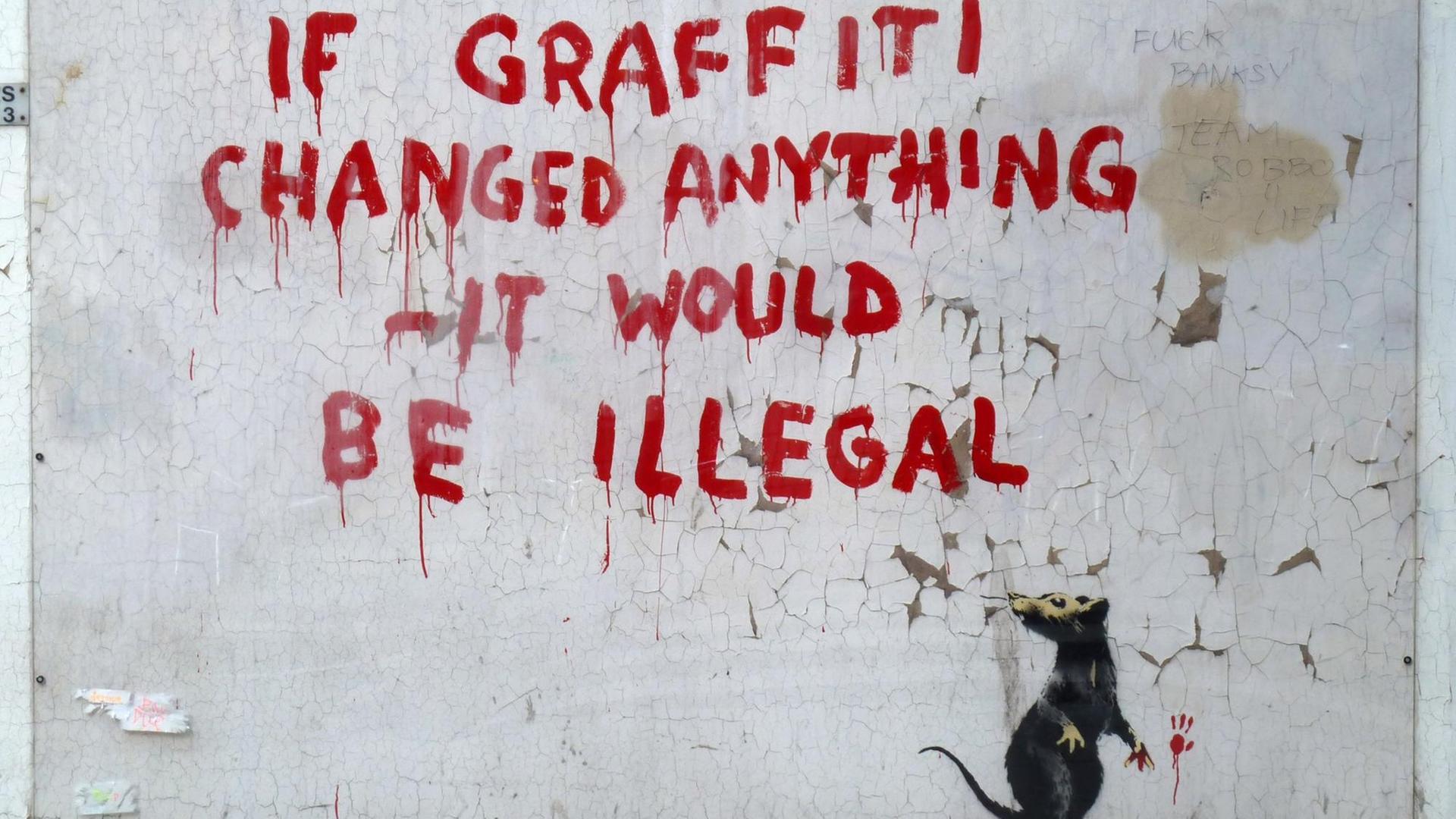 LONDON, ENGLAND - OCTOBER 6: A new stencil and spray paint artwork, by guerilla graffiti artist Banksy, appears in Fitzrovia, October 6, 2011 in London, England. The piece, that shows a rat having written a message which reads "If Graffiti changed anything - it would be illegal", has been covered in plexiglass in order to protect it. (Photo by Jim Dyson/Getty Images)