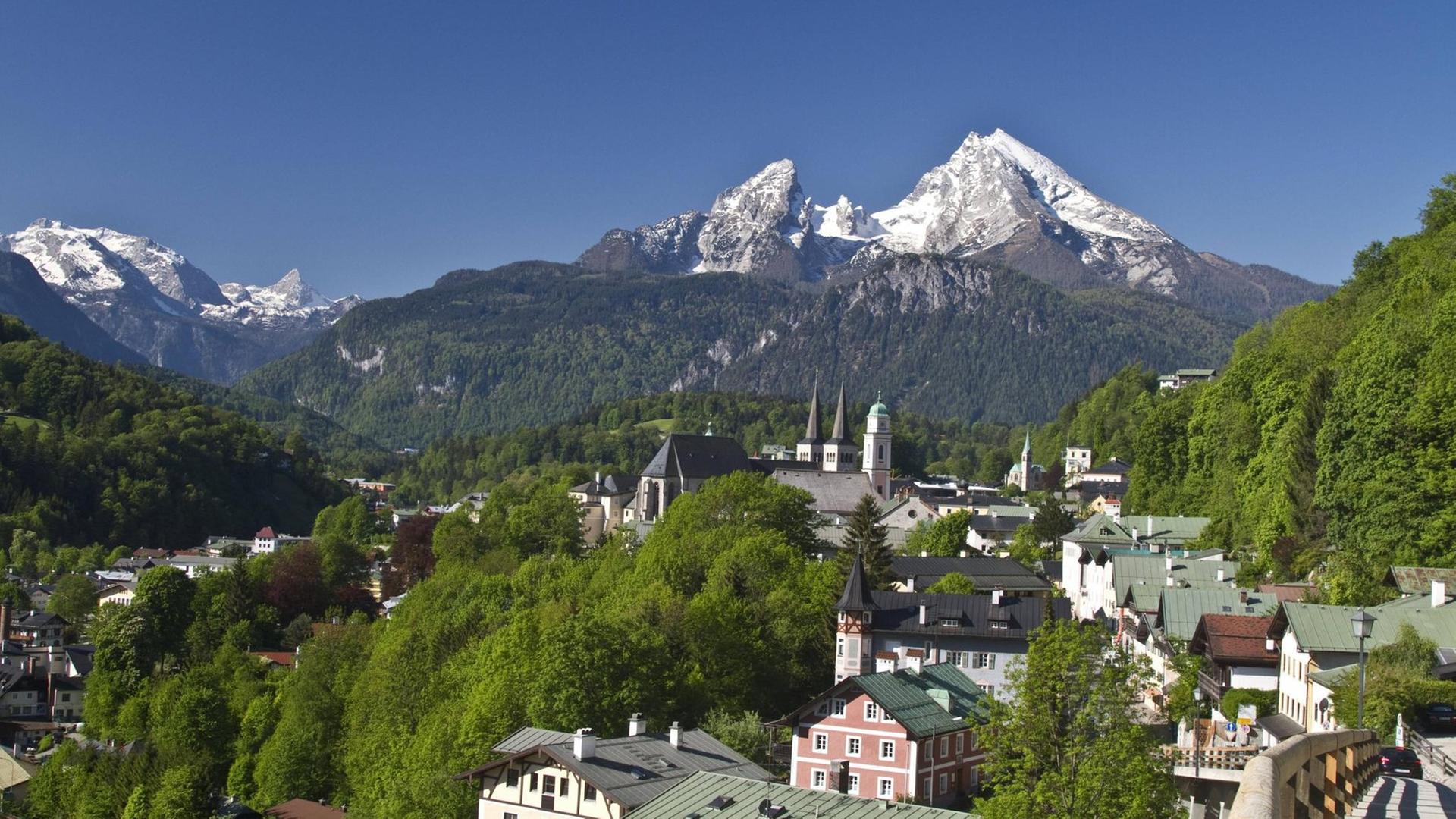 Panoramablick auf die Stadt Berchtesgaden in Bayern und die dahinterliegenden Berge.