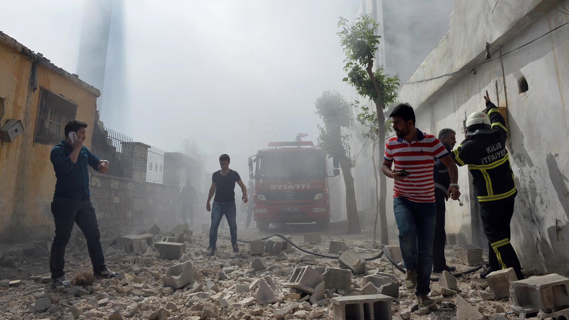 Nach Raketenangriffen auf Kilis (Bild) hat die Türkei IS-Stellungen in Syrien angegriffen. Menschen laufen durch die Trümmer in den Straßen.