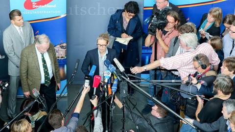 Alexander Gauland und Alice Weidel, umringt von Mikrofonen und Journalisten.